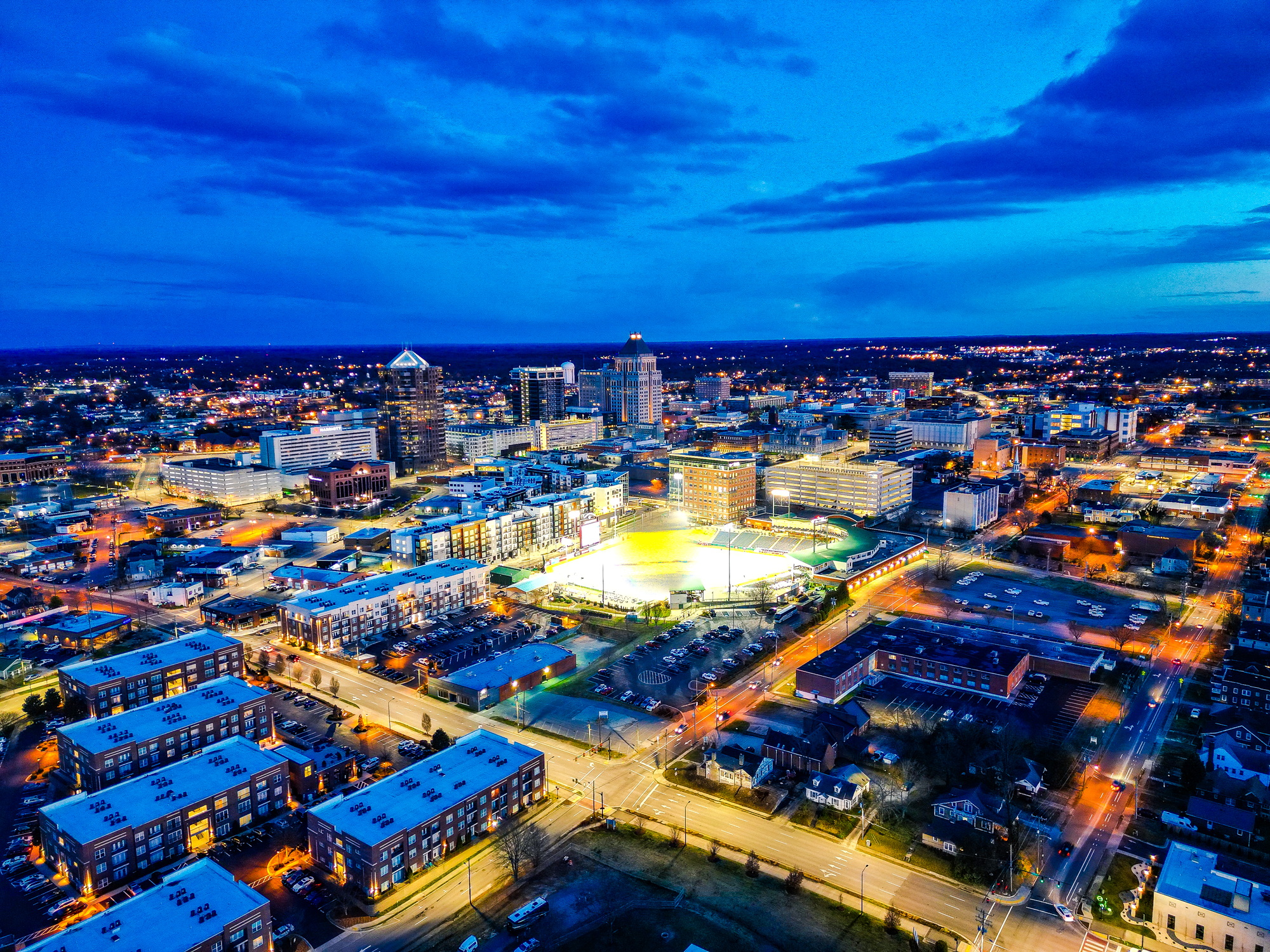 Aerial view of Greensboro, NC city lights at dusk