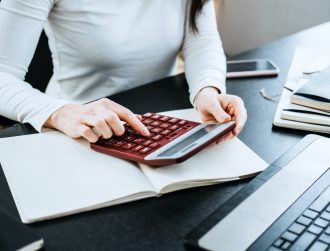 Accounting Formulas Equations for Accountants. Female Accountant working with calculator and laptop