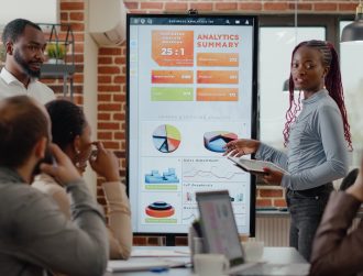 African american people receiving applause from colleagues at business meeting