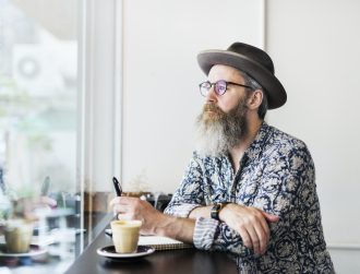 An author making notes in a coffee shop