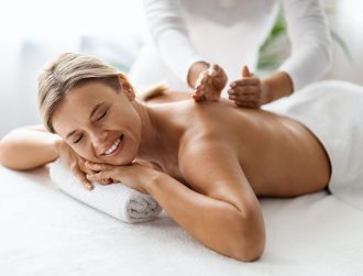 Beautiful Middle Aged Woman Enjoying Professional Wellness Massage In Spa Salon