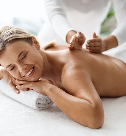 Beautiful Middle Aged Woman Enjoying Professional Wellness Massage In Spa Salon
