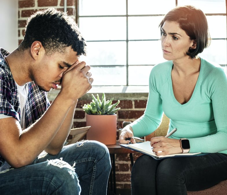 Black man consulting with a therapist