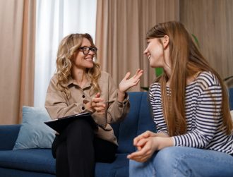 Encouraging therapist talks with young woman