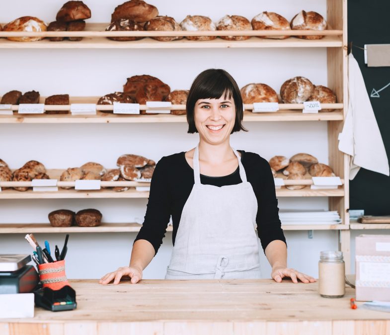 Local business owner or bakery worker behind the counter