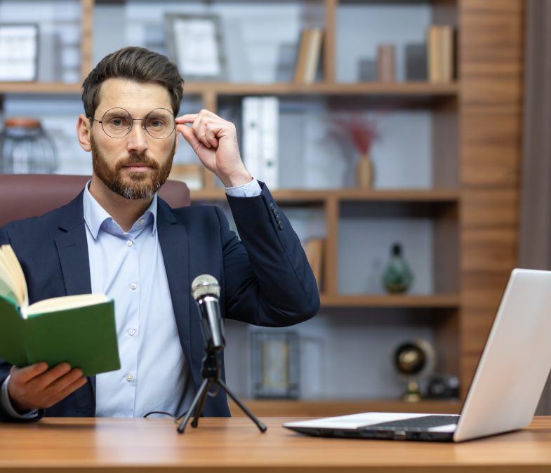 Online presentation of the book. Record a podcast. A young man writer, author, translator in a suit