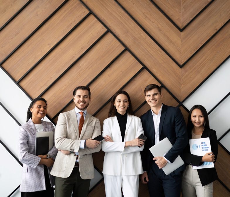 smiling young and old multiracial workers staff group pose together as human resource