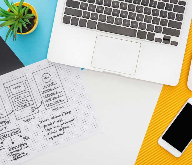 top view of website design template near laptop, computer mouse, smartphone, plant on abstract