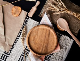 Wooden plate, tray, layout, kitchen cutlery flat lay with wheat grains. A place for branding.